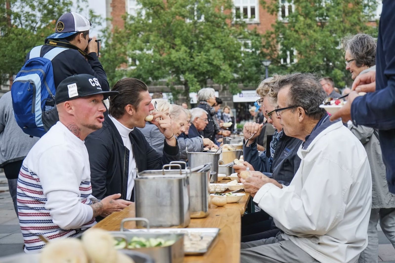Babette’s Town Feast: guests eating and talking at the shared table