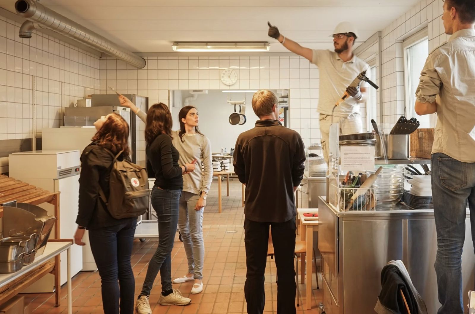 The food team and a builder planning the kitchen fit-out in a tiled kitchen