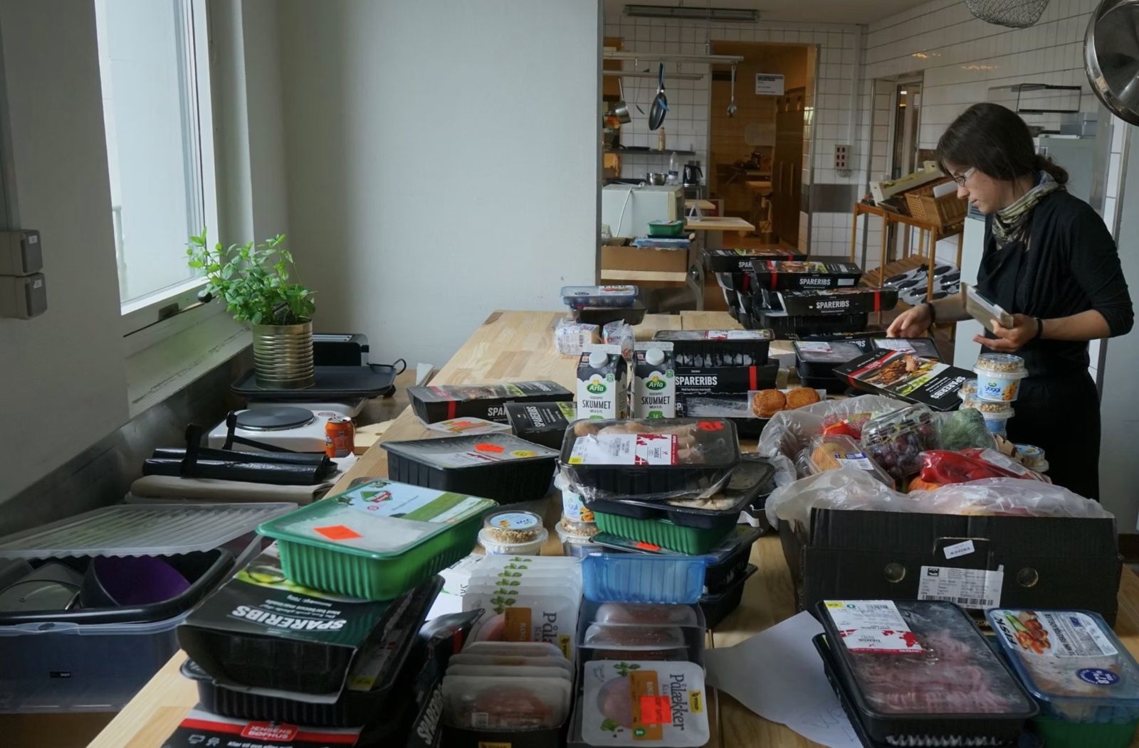 Sorting donated supermarket surplus food on a kitchen table