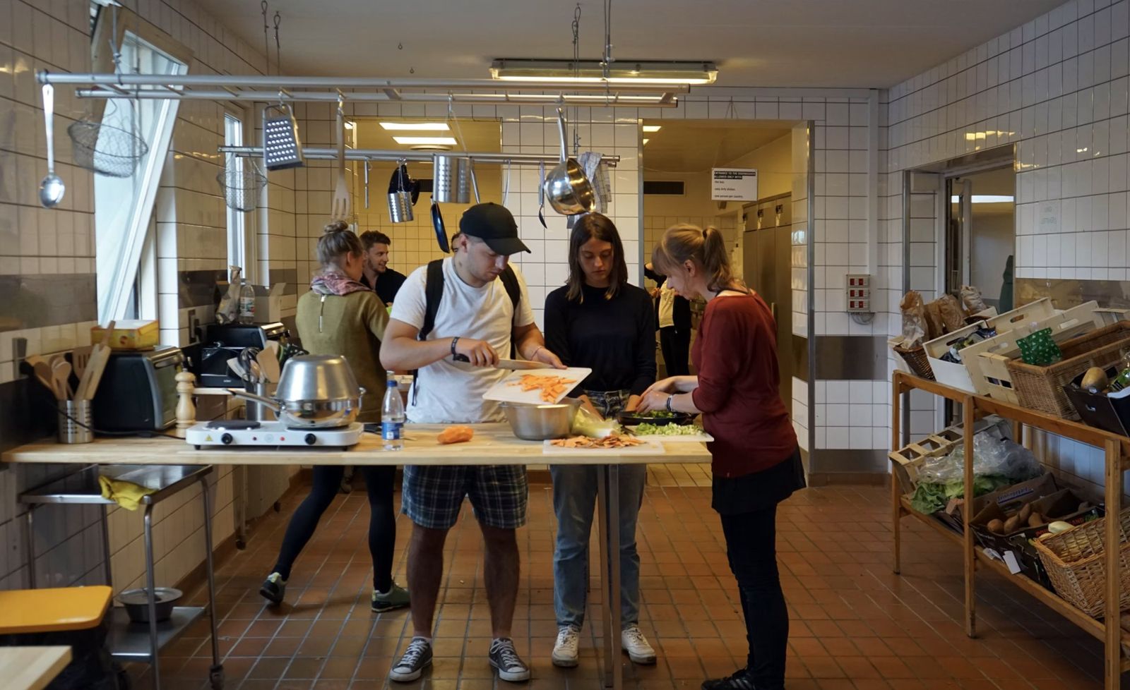 People cooking together around a worktable in the Fredericia Food Lab